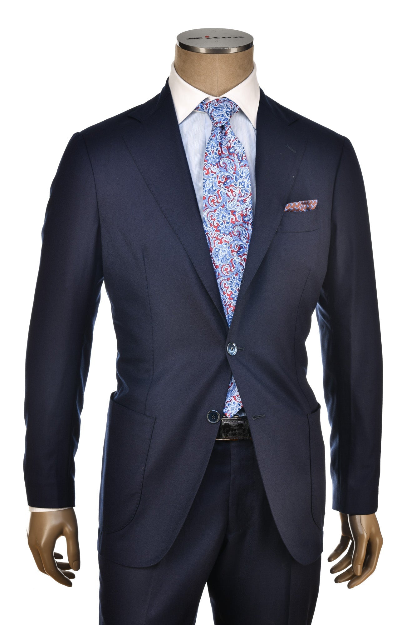 Navy suit with a patterned tie and pocket square on a mannequin against a white background