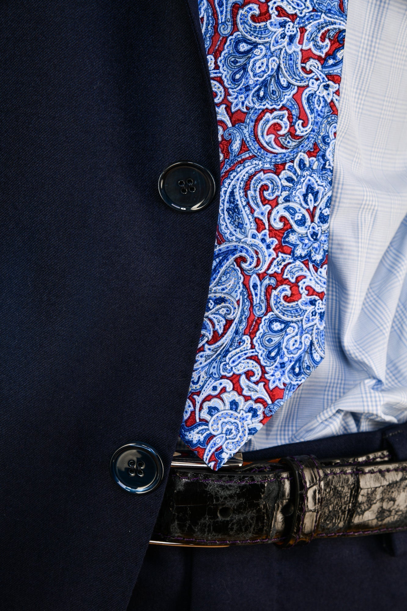 Navy blazer with a patterned lining and a button detail.