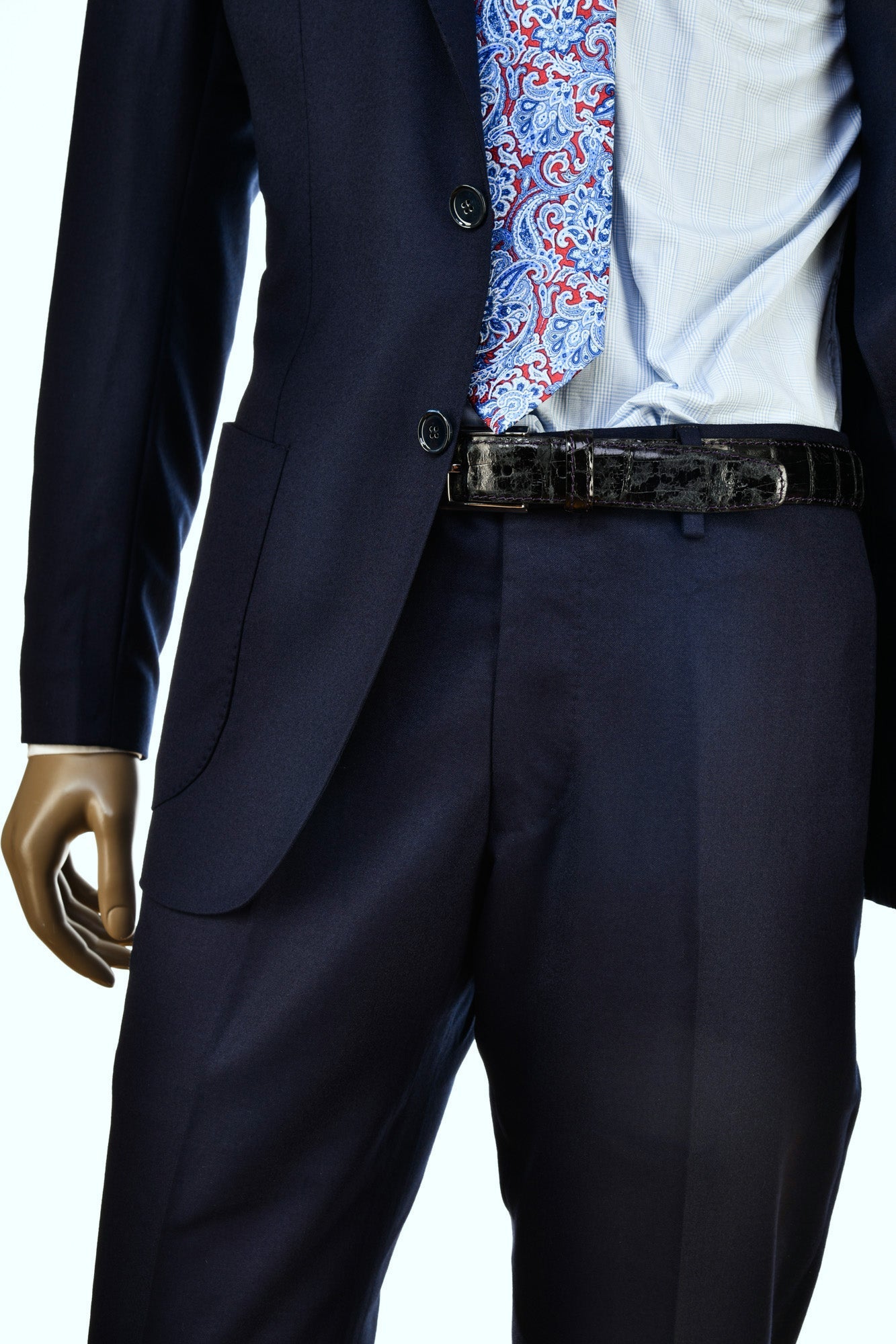 Navy suit with a patterned shirt and belt on a white background