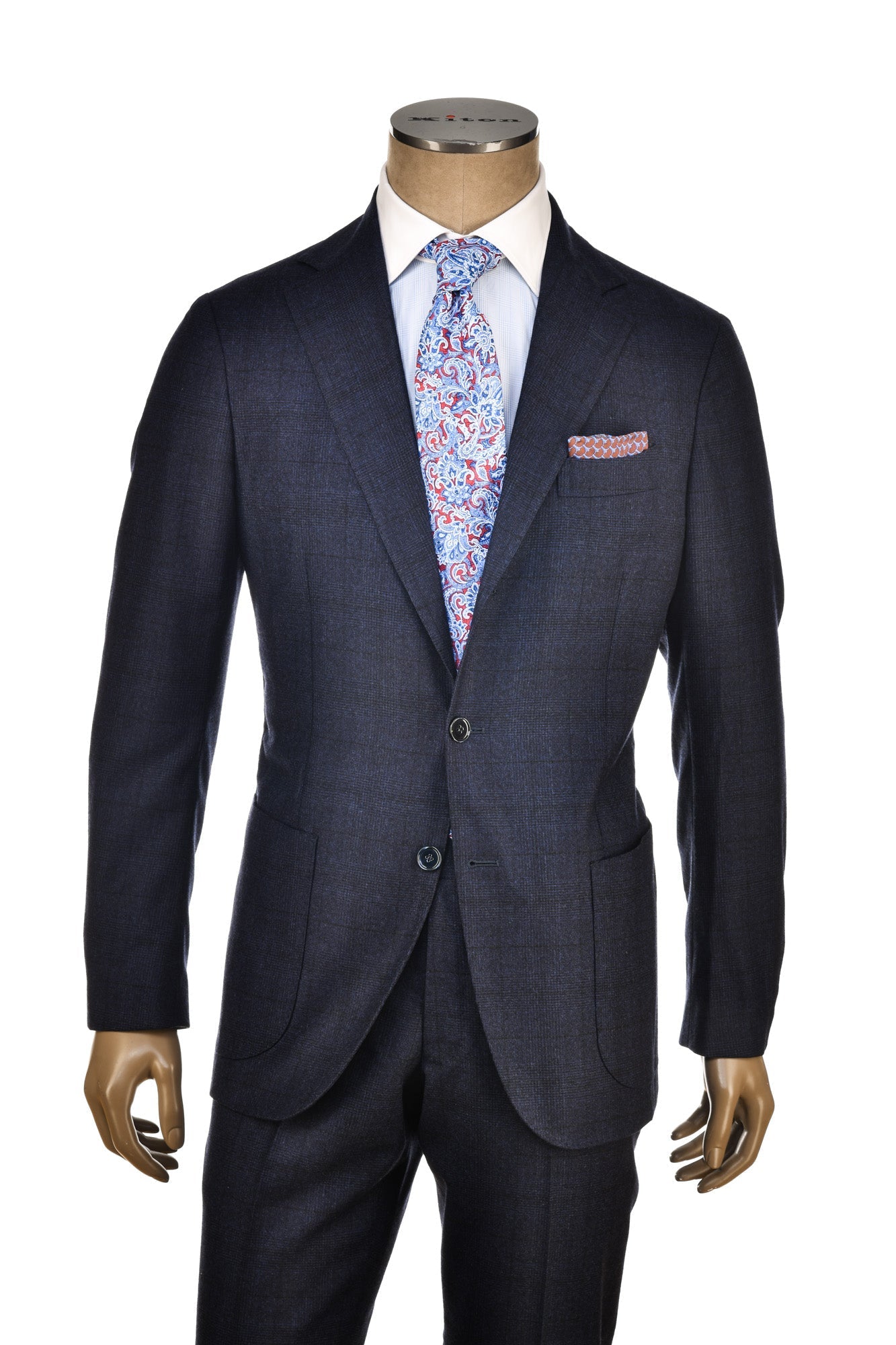 Navy suit with a floral tie and pocket square on a mannequin against a white background
