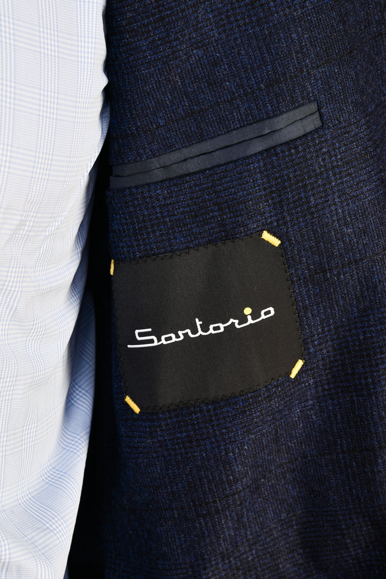 Navy suit jacket with 'Santorio' label on a white shirt background