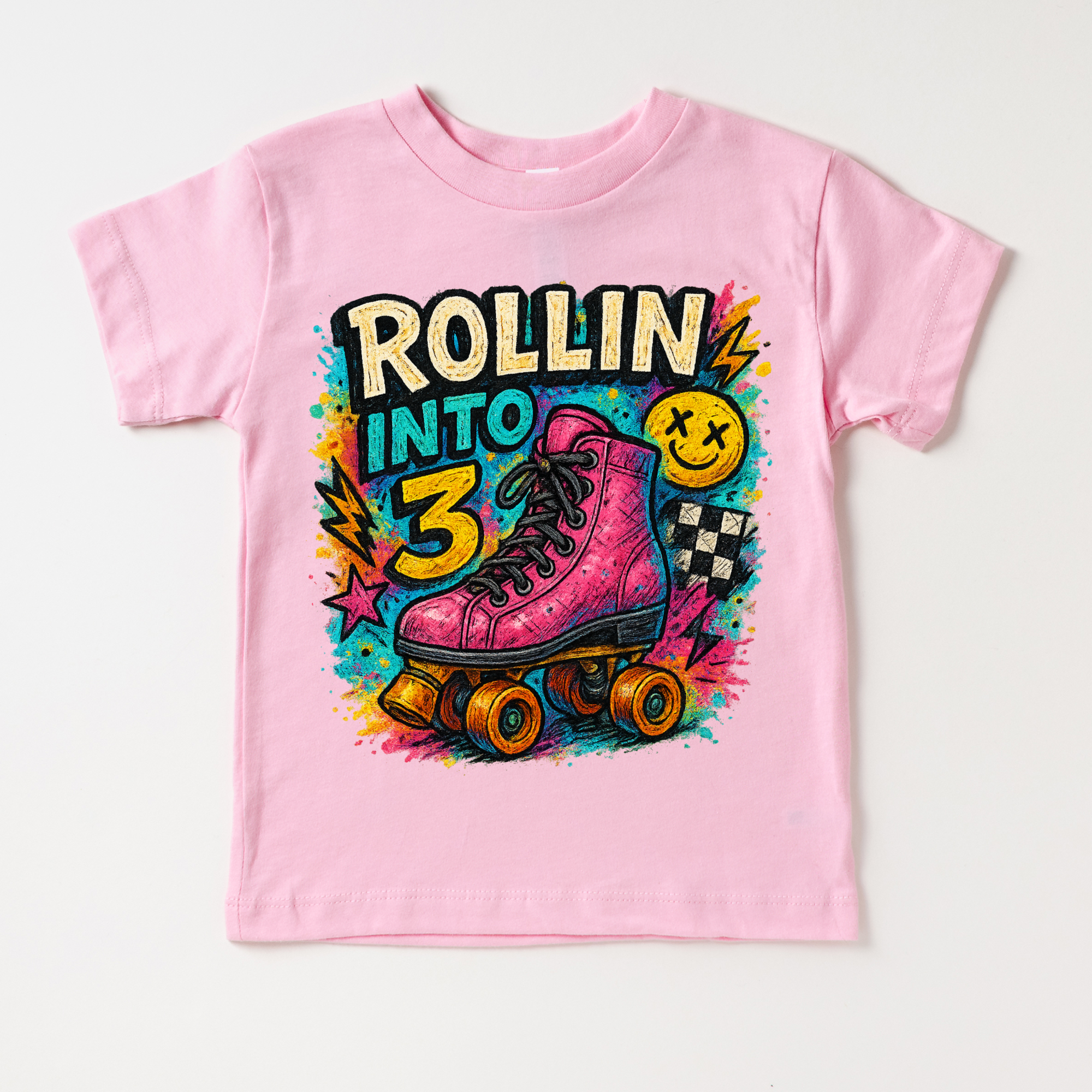 Pink t-shirt with roller skate graphic and 'Rollin into 3' text on a white background
