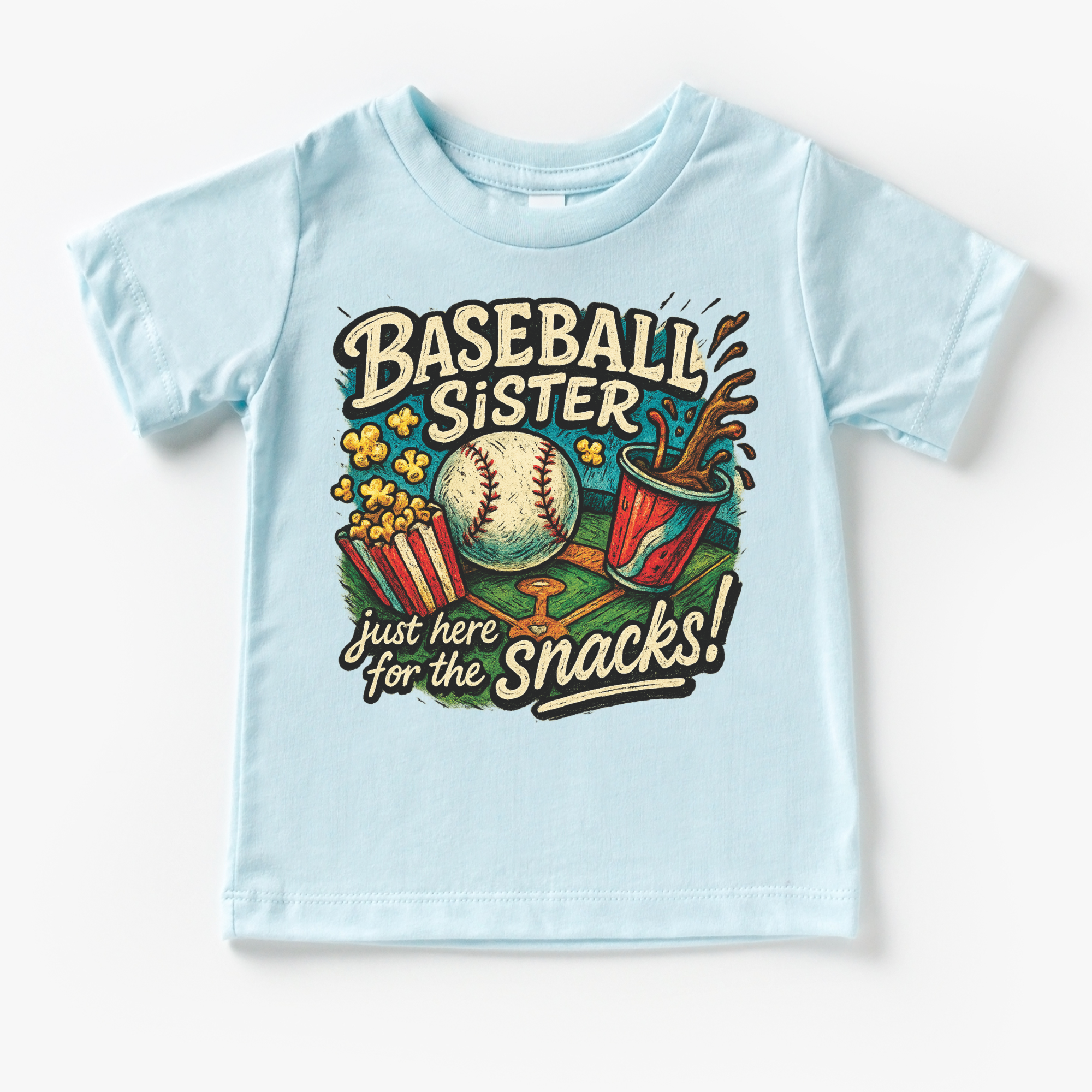 Light blue t-shirt with 'Baseball Sister, just here for the snacks!' graphic design on a white background