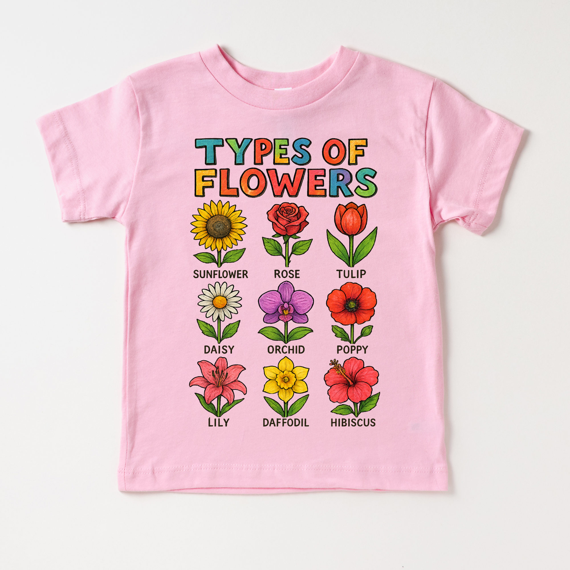 Pink t-shirt with colorful flower illustrations and names on a white background