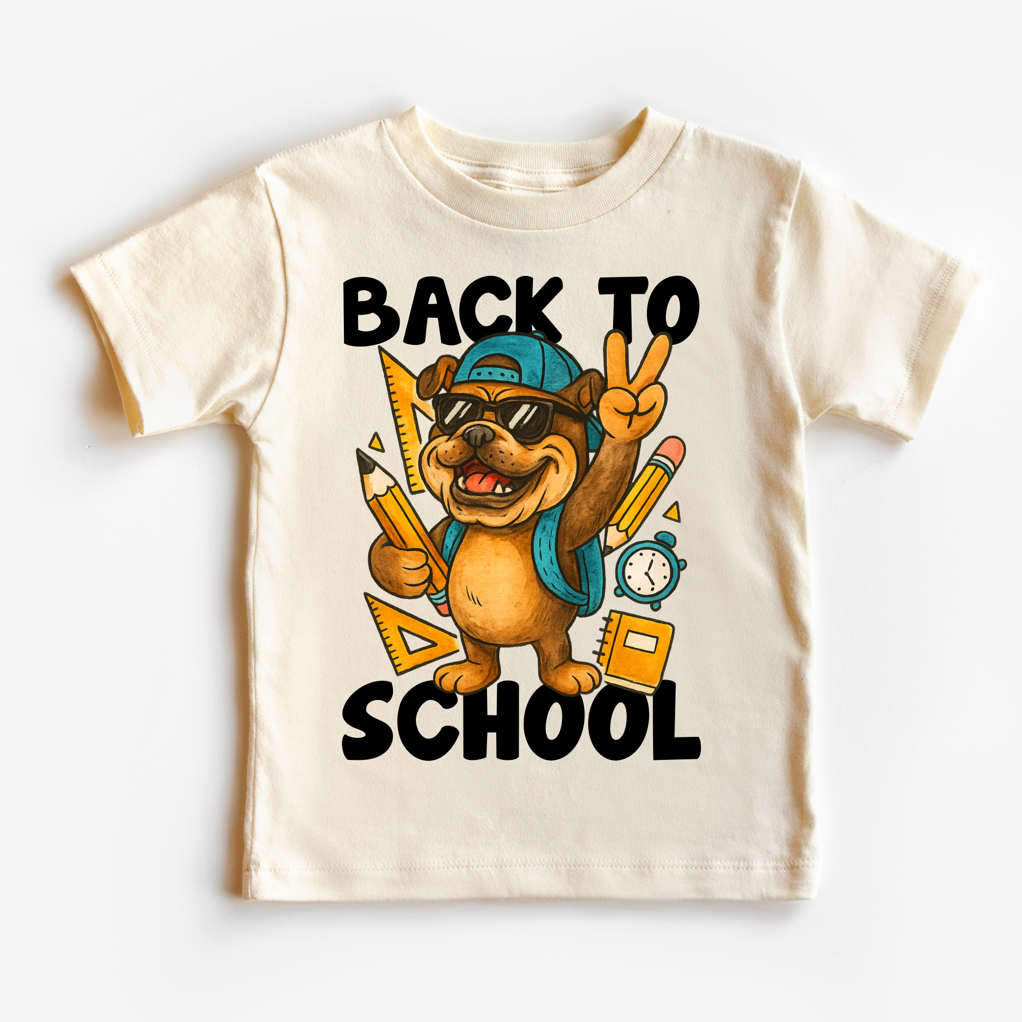 Children's t-shirt with a cartoon dog holding school supplies and 'Back to School' text on a white background.
