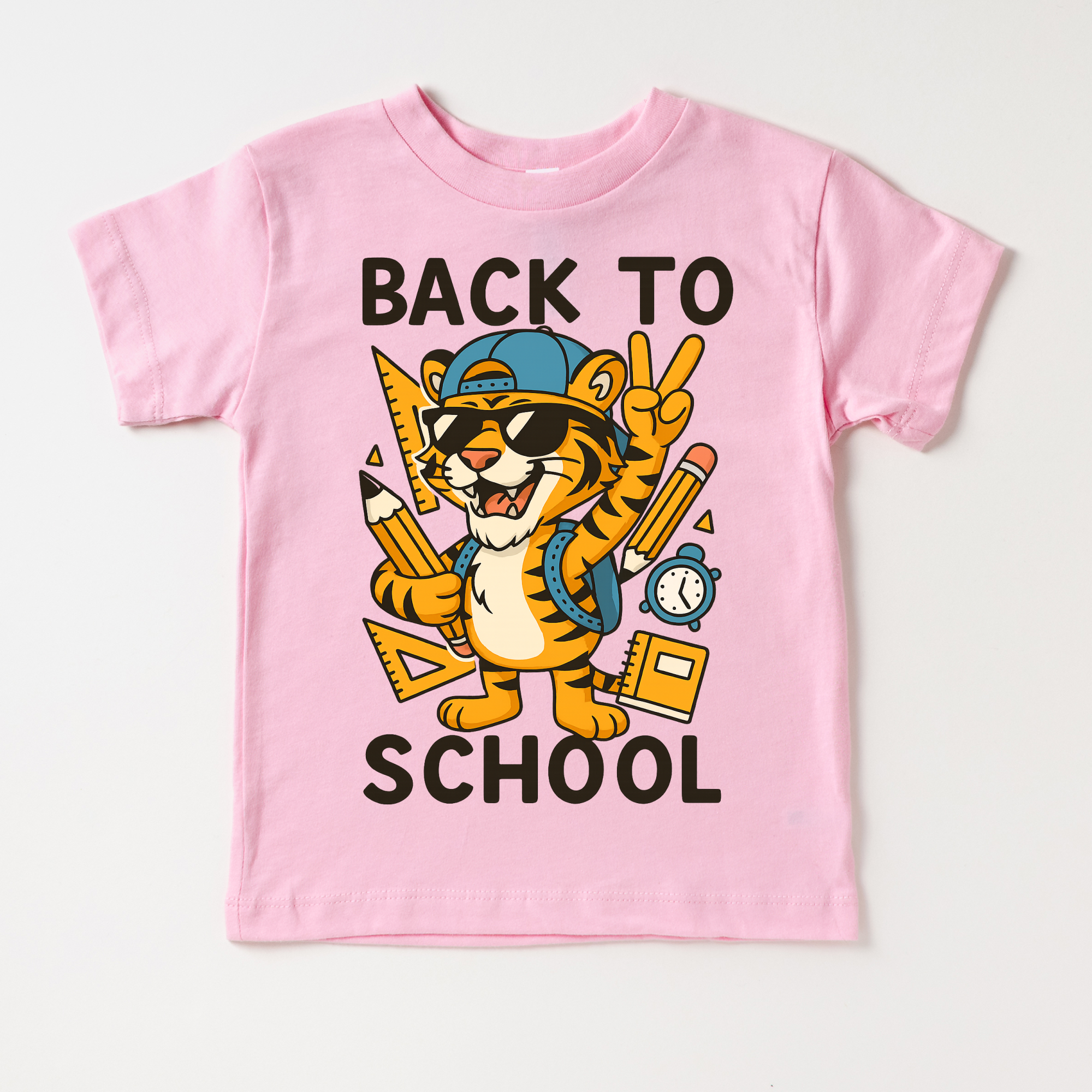 Pink t-shirt with a tiger graphic and 'Back to School' text on a white background