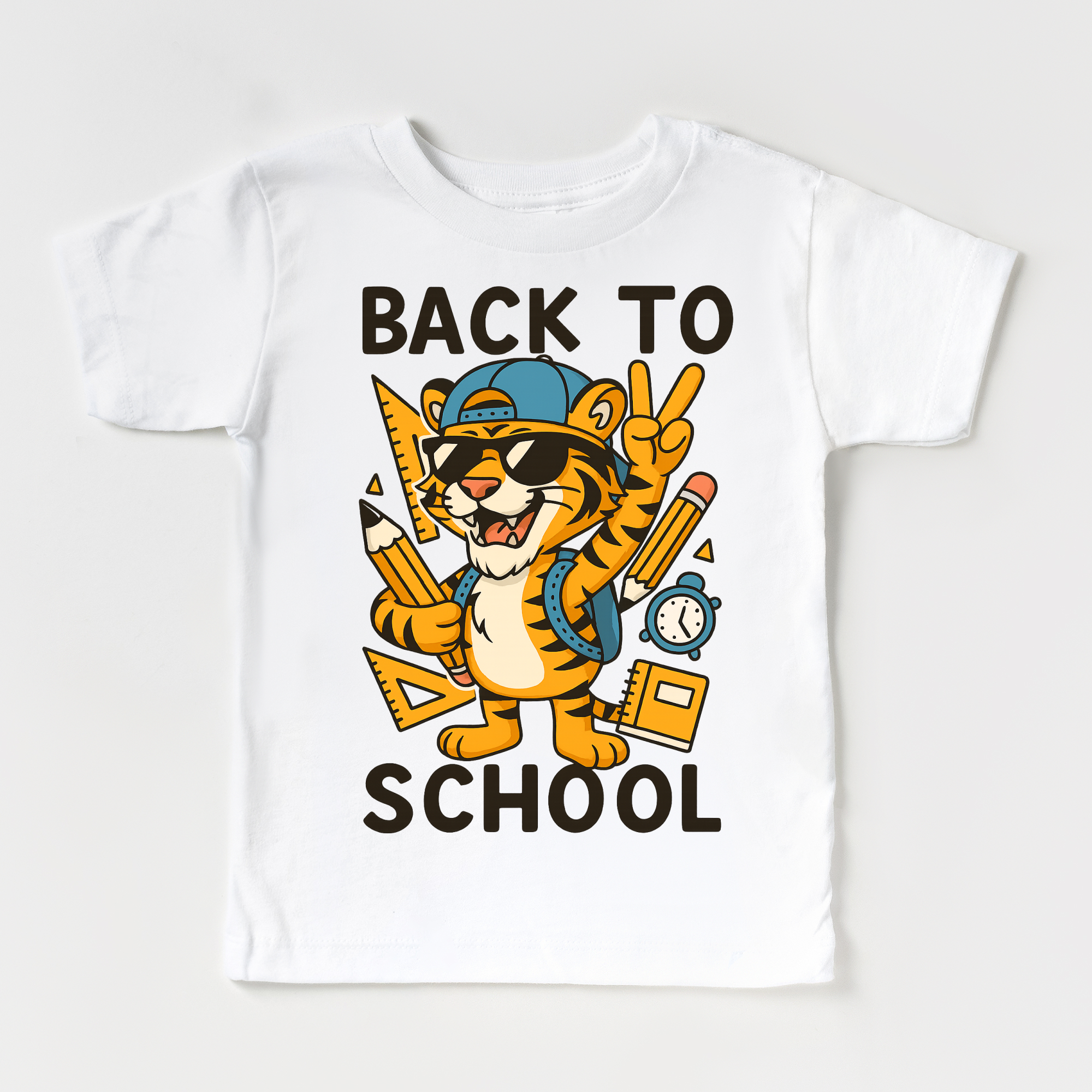 White t-shirt with a cartoon tiger holding school supplies and 'Back to School' text on a white background