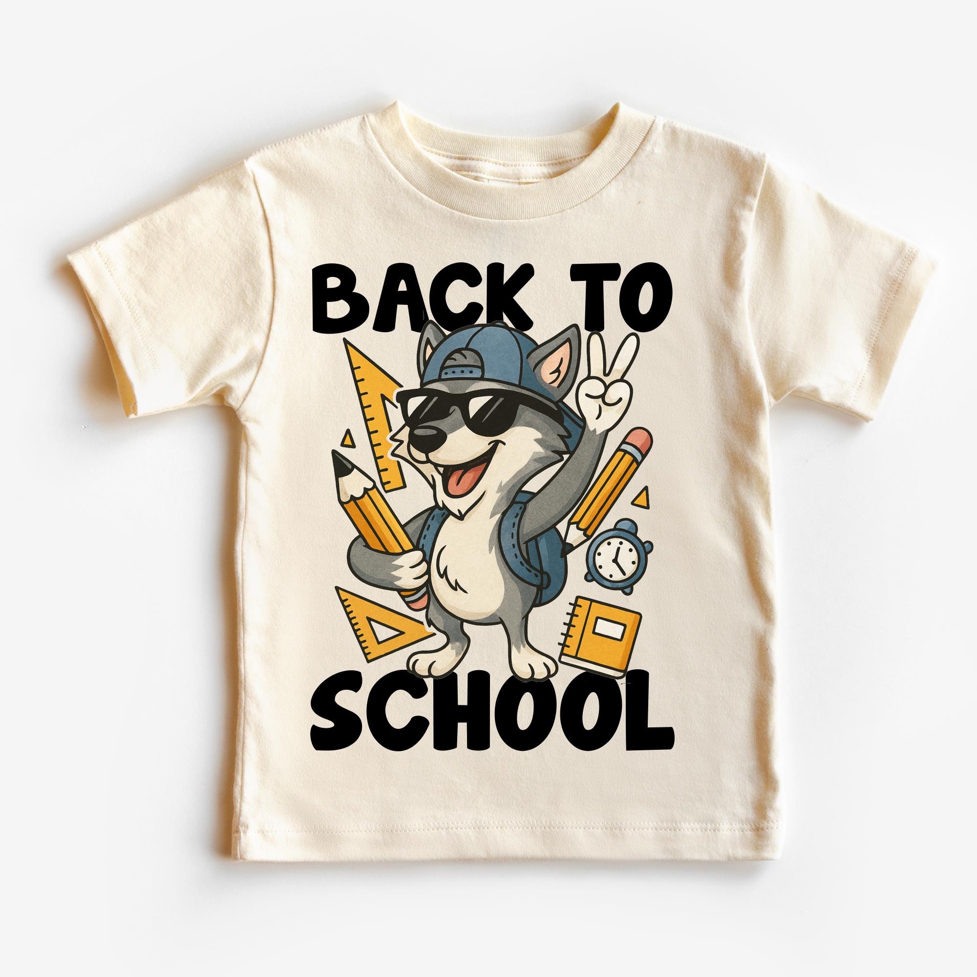 Children's t-shirt with a cartoon dog wearing sunglasses, a cap, and backpack, holding pencils and a ruler with 'Back to School' text.