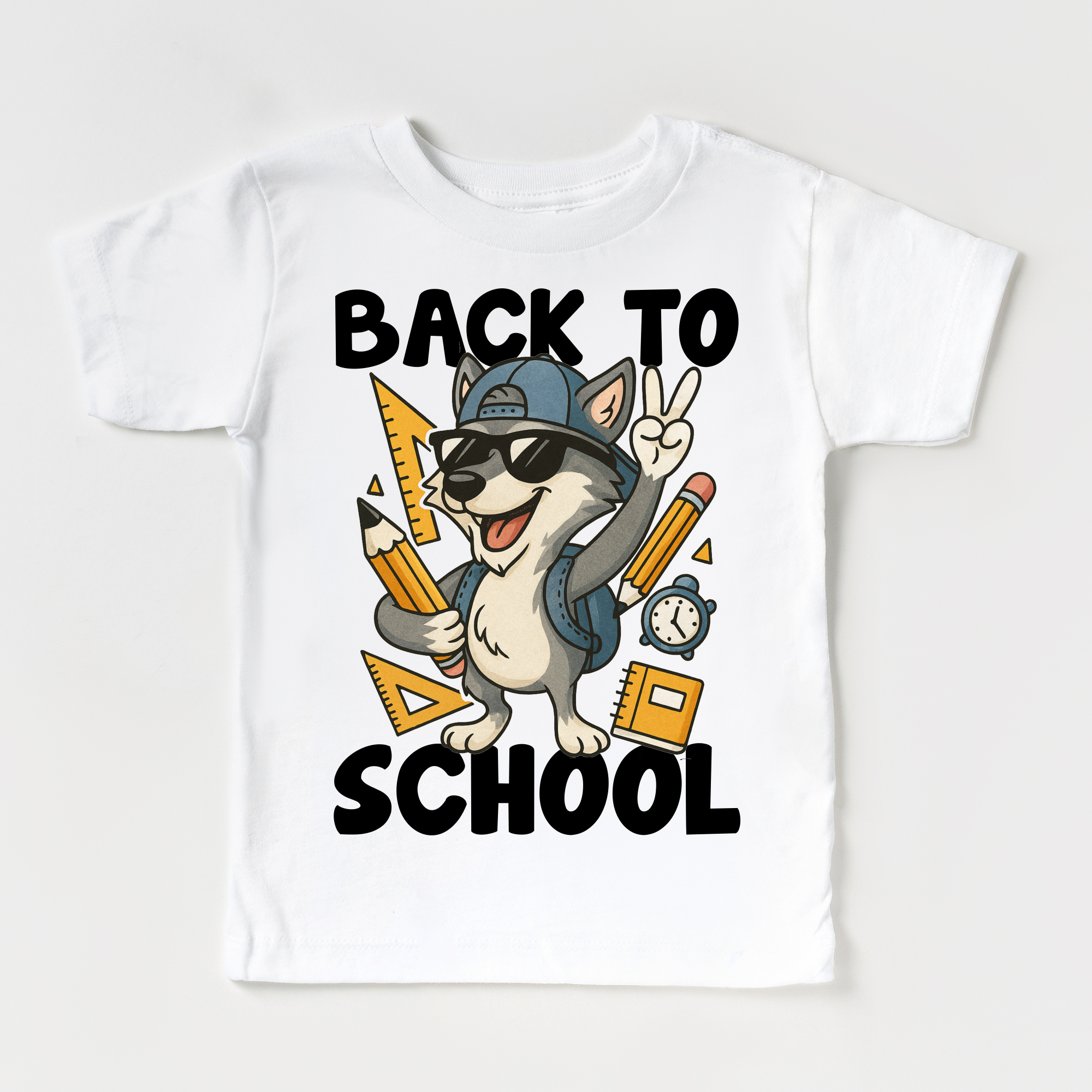 White t-shirt with a cartoon dog wearing sunglasses and a cap, holding pencils and a backpack, with 'Back to School' text on a white background.