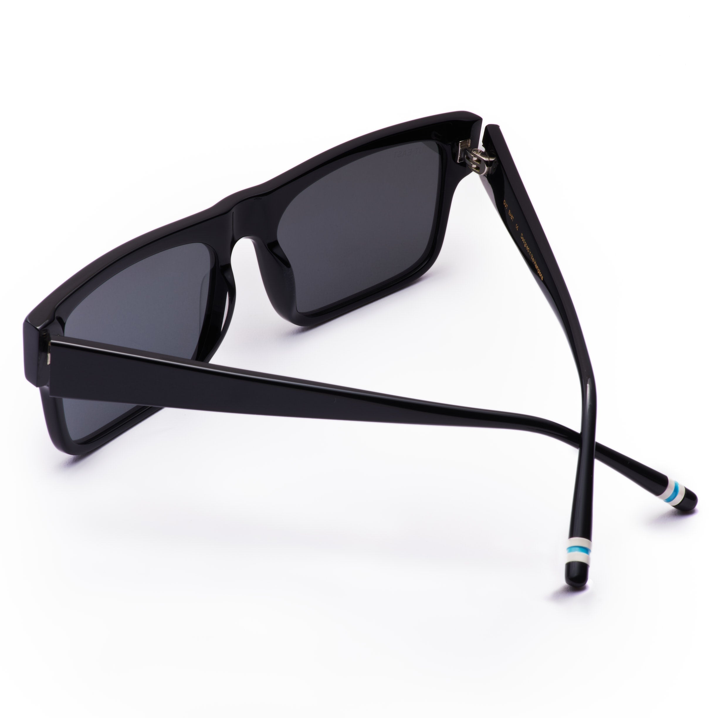Black sunglasses with dark lenses on a white background