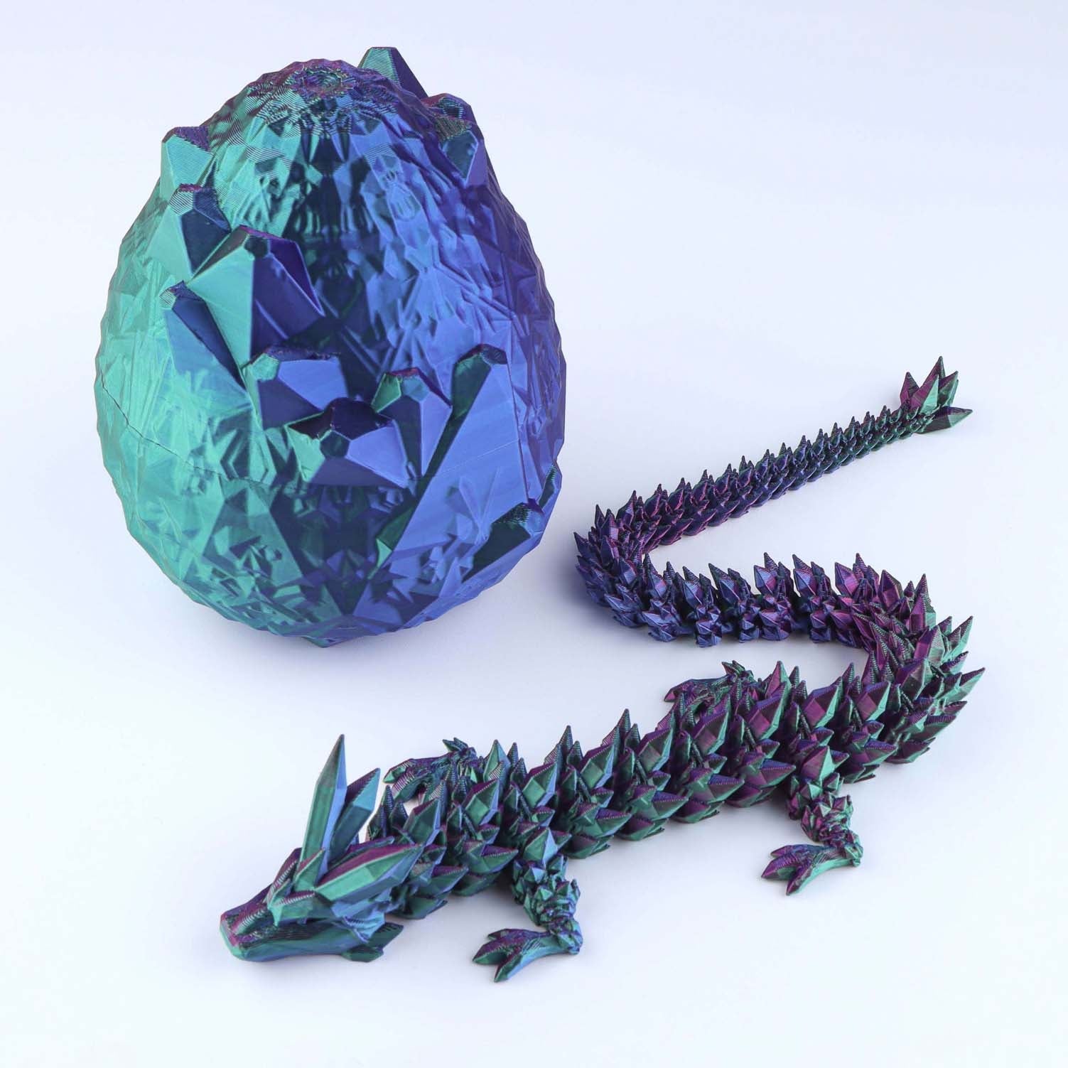 Colorful dragon egg and dragon model on a white background