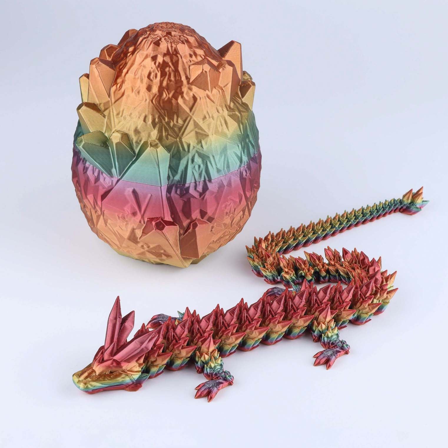 Colorful dragon-shaped toy with a metallic egg on a white background