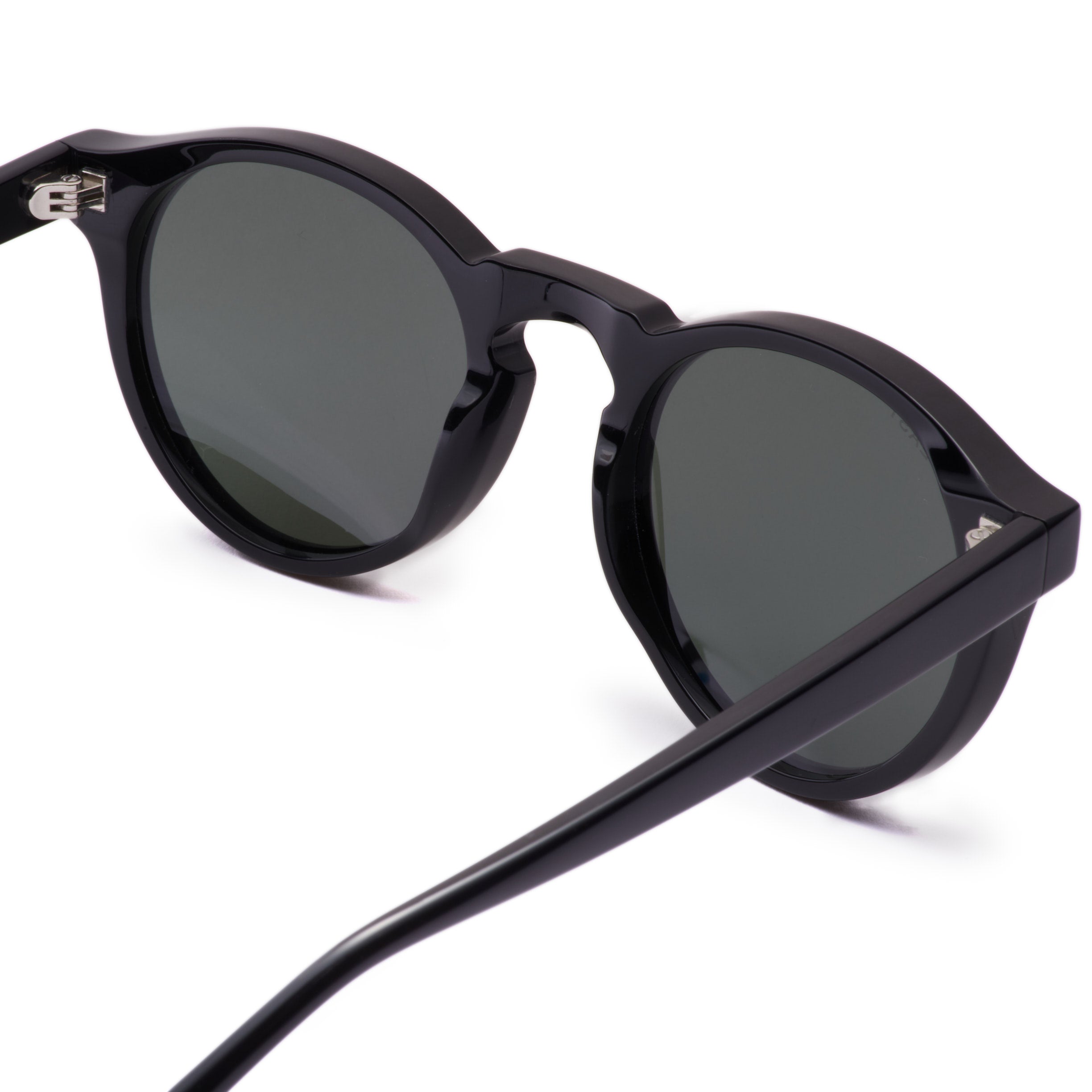 Black sunglasses with dark lenses on a white background
