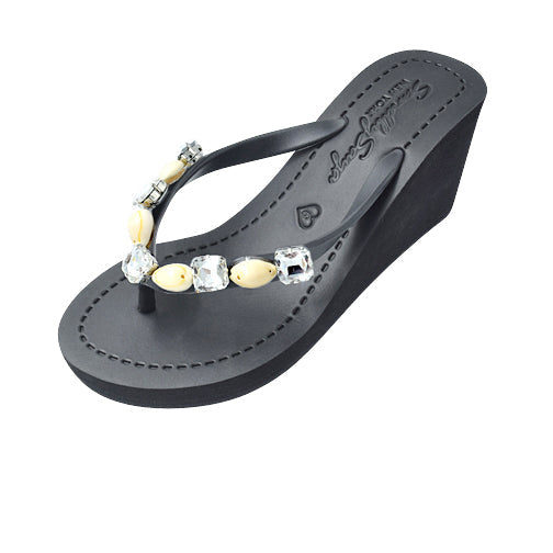 Black sandal with decorative gemstones on a white background