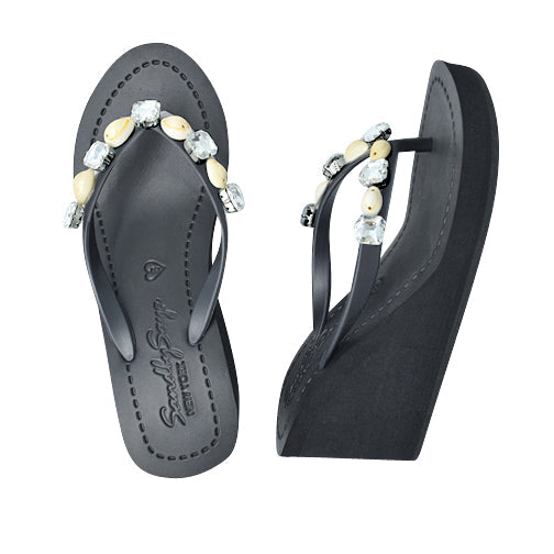 Black flip-flops with decorative beads and crystals on a white background