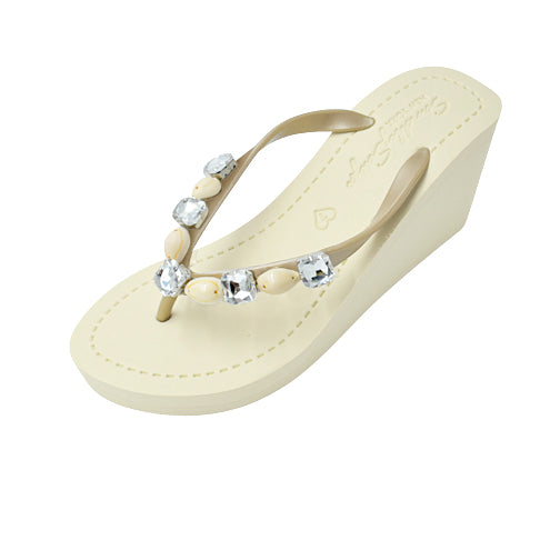 Beige sandal with decorative stones on a white background