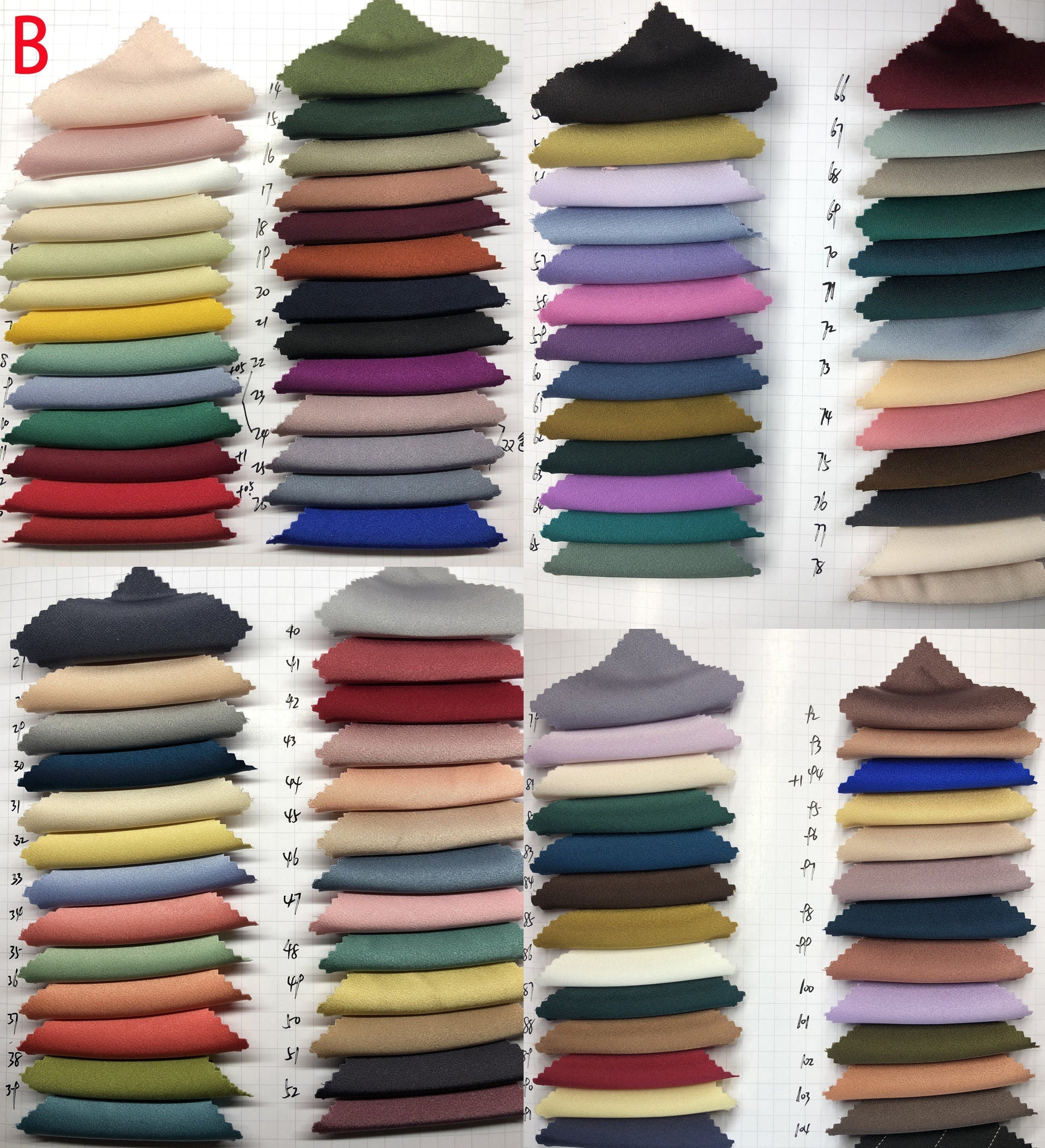 Collection of folded fabric swatches in various colors on a white background