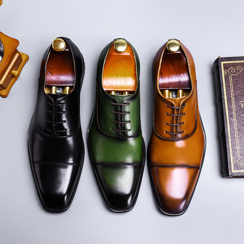Three pairs of men's dress shoes in black, green, and brown on a light gray background.