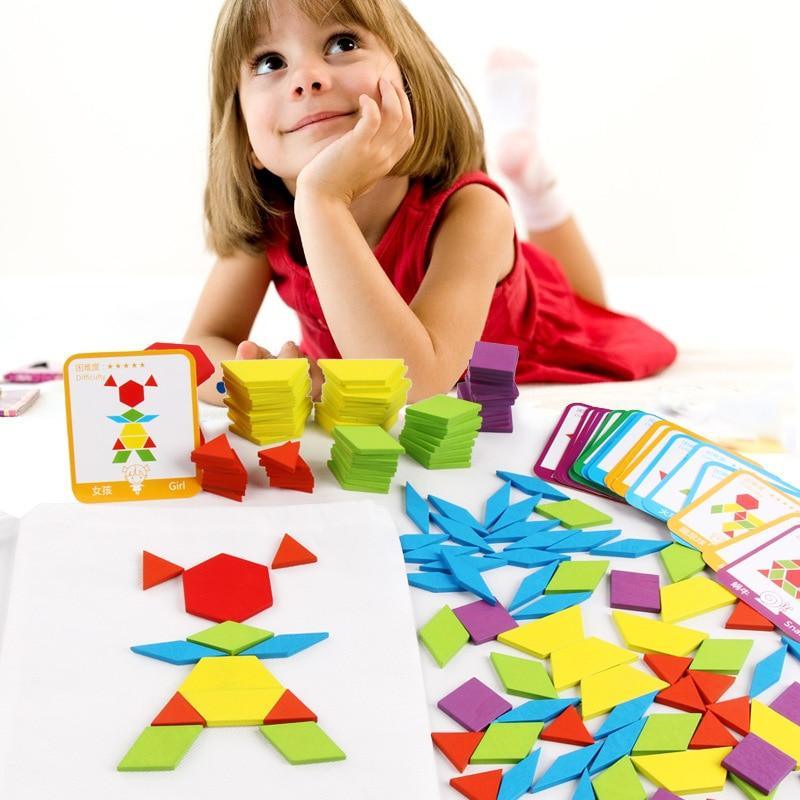 Child playing with colorful geometric shapes and cards on a white background