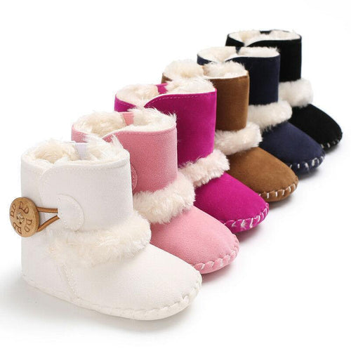 Set of colorful baby booties with fur trim on a white background