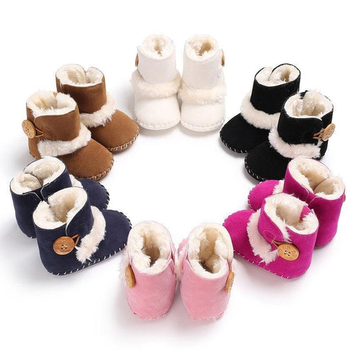 Set of colorful baby booties with fur trim on a white background