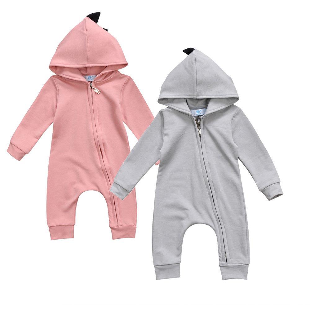 Pink and gray baby rompers with hoodies on a white background