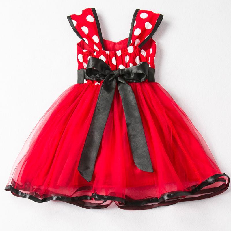 Red polka dot dress with a black bow on a white background