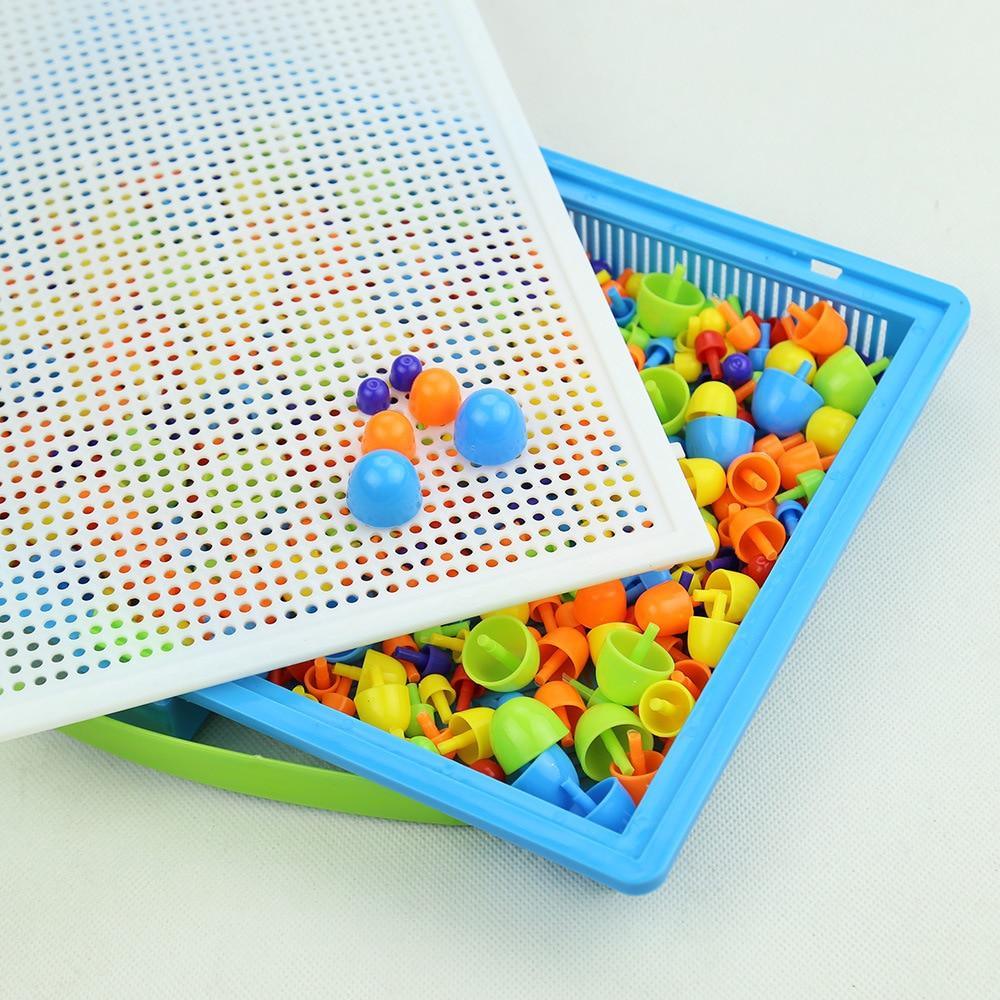 Colorful plastic balls in a blue tray with a perforated white board on a light gray background