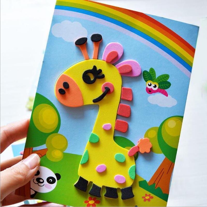 Colorful craft paper with a giraffe design held by a hand against a white background