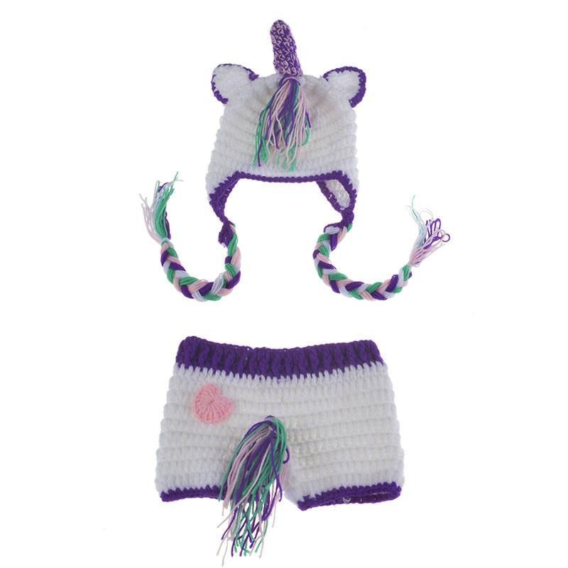 Crocheted unicorn hat and diaper cover set on a white background