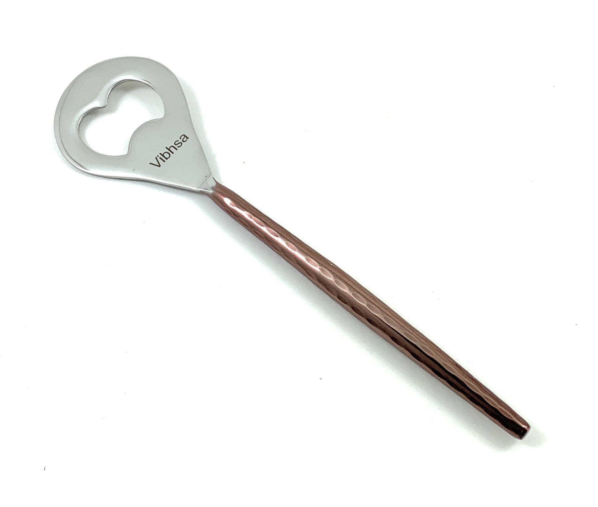 Metallic spoon with heart-shaped handle and rose gold accent on a white background