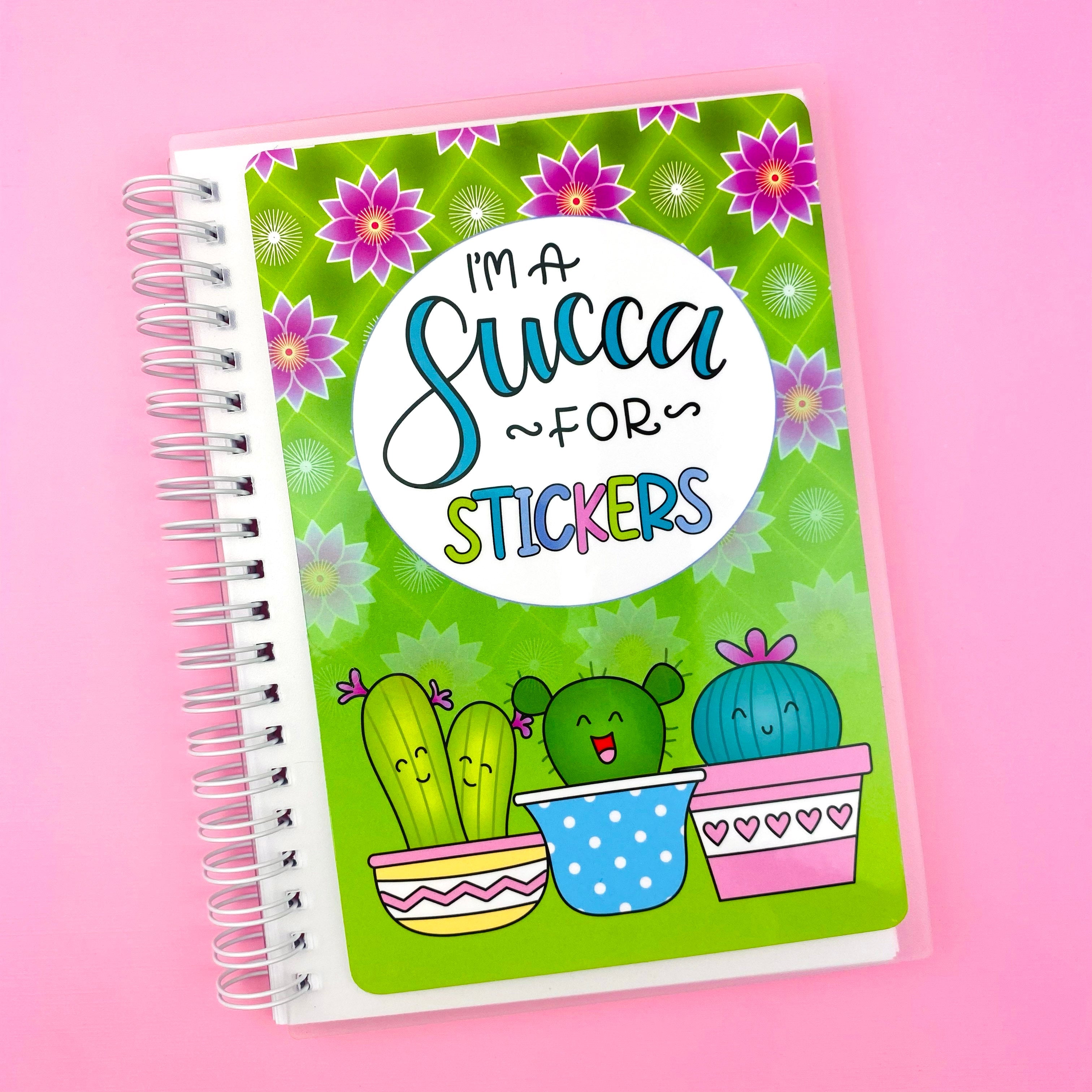 Notebook with succulent design and text on a pink background