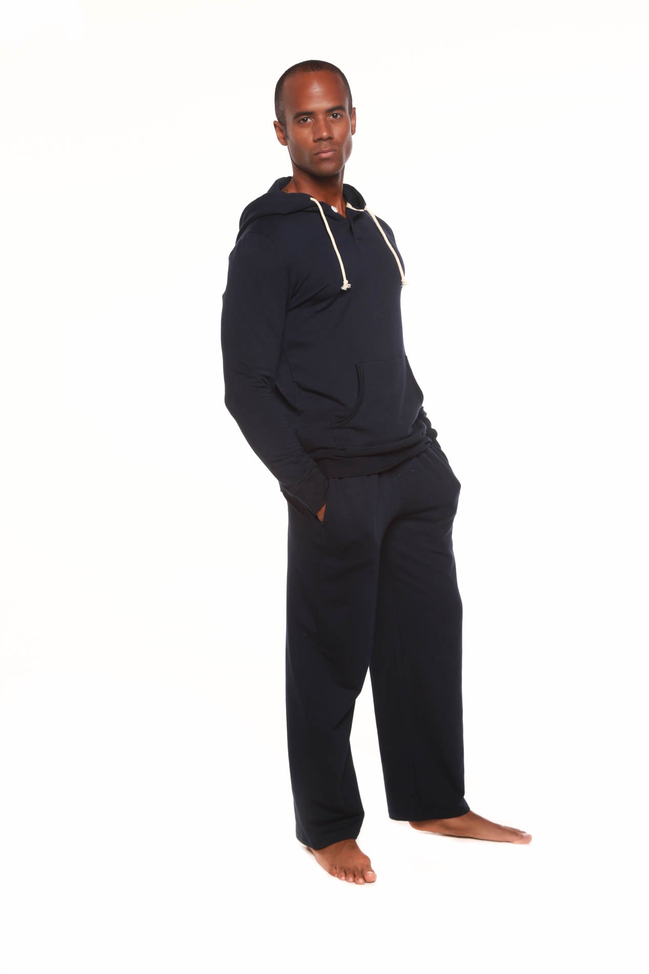 Man wearing a navy blue onesie on a white background