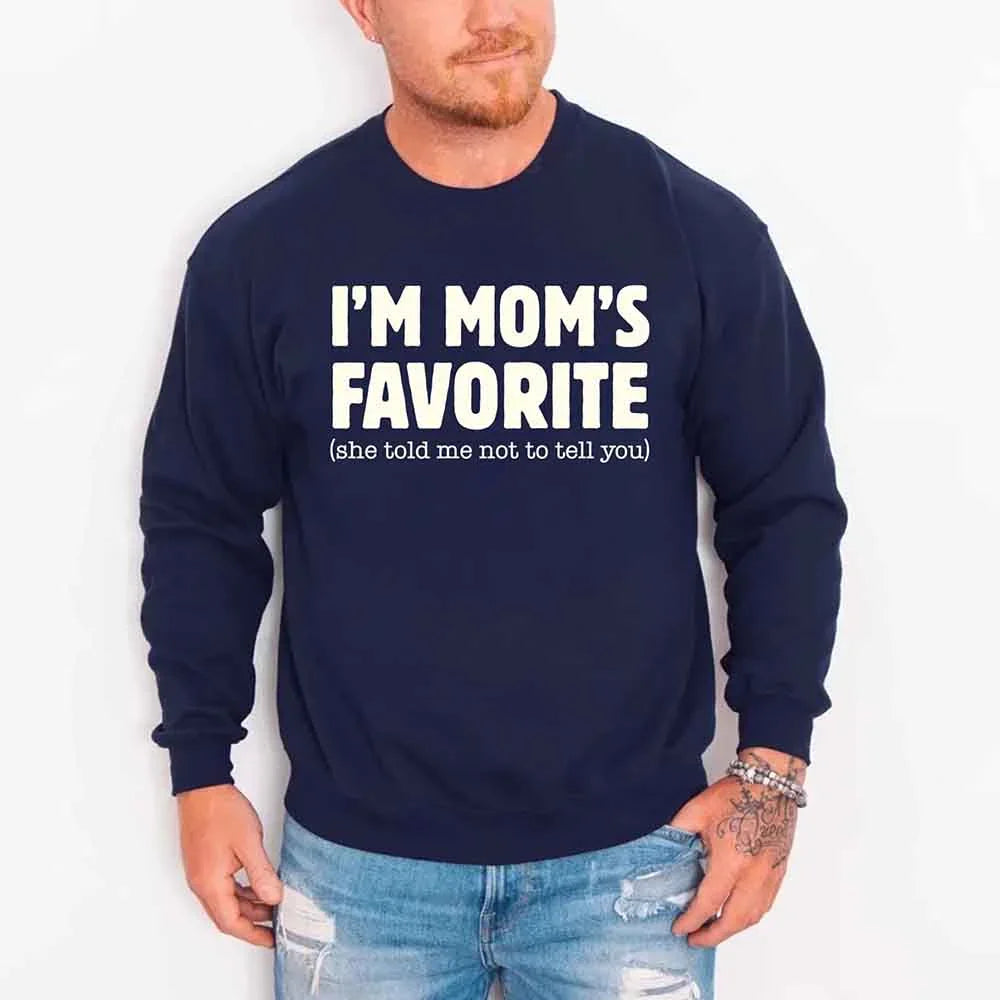 Person wearing a navy sweatshirt with 'I'm Mom's Favorite (she told me not to tell you)' text.