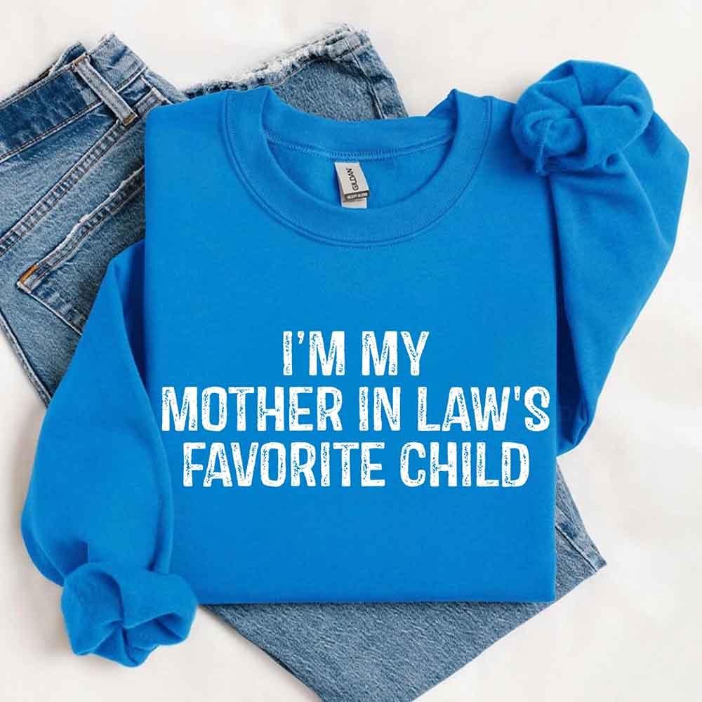 Blue sweatshirt with 'I'm my mother in law's favorite child' text on a white background