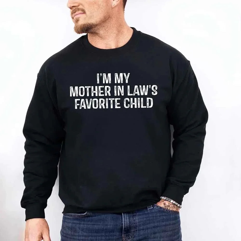 Person wearing a black sweatshirt with text 'I'm my mother-in-law's favorite child' on a white background