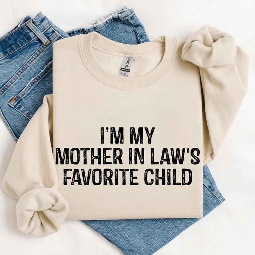 Beige sweatshirt with 'I'm my mother in law's favorite child' text on a white background