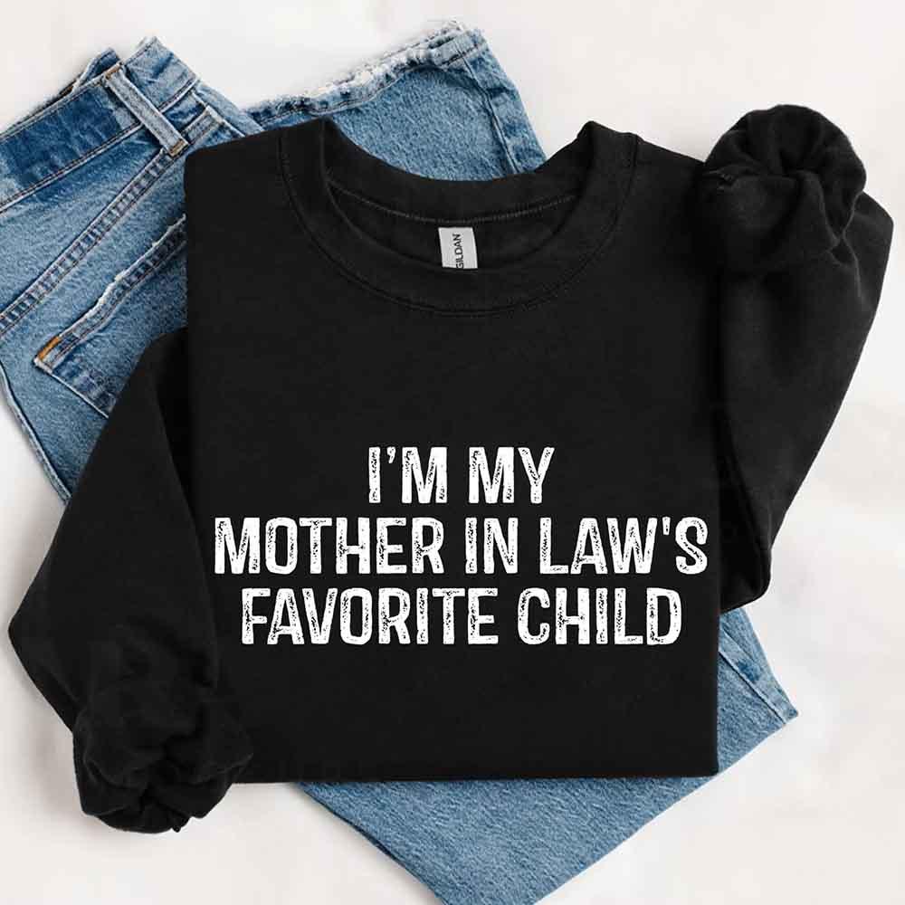 Black sweatshirt with text 'I'm my mother in law's favorite child' on a white background with jeans.