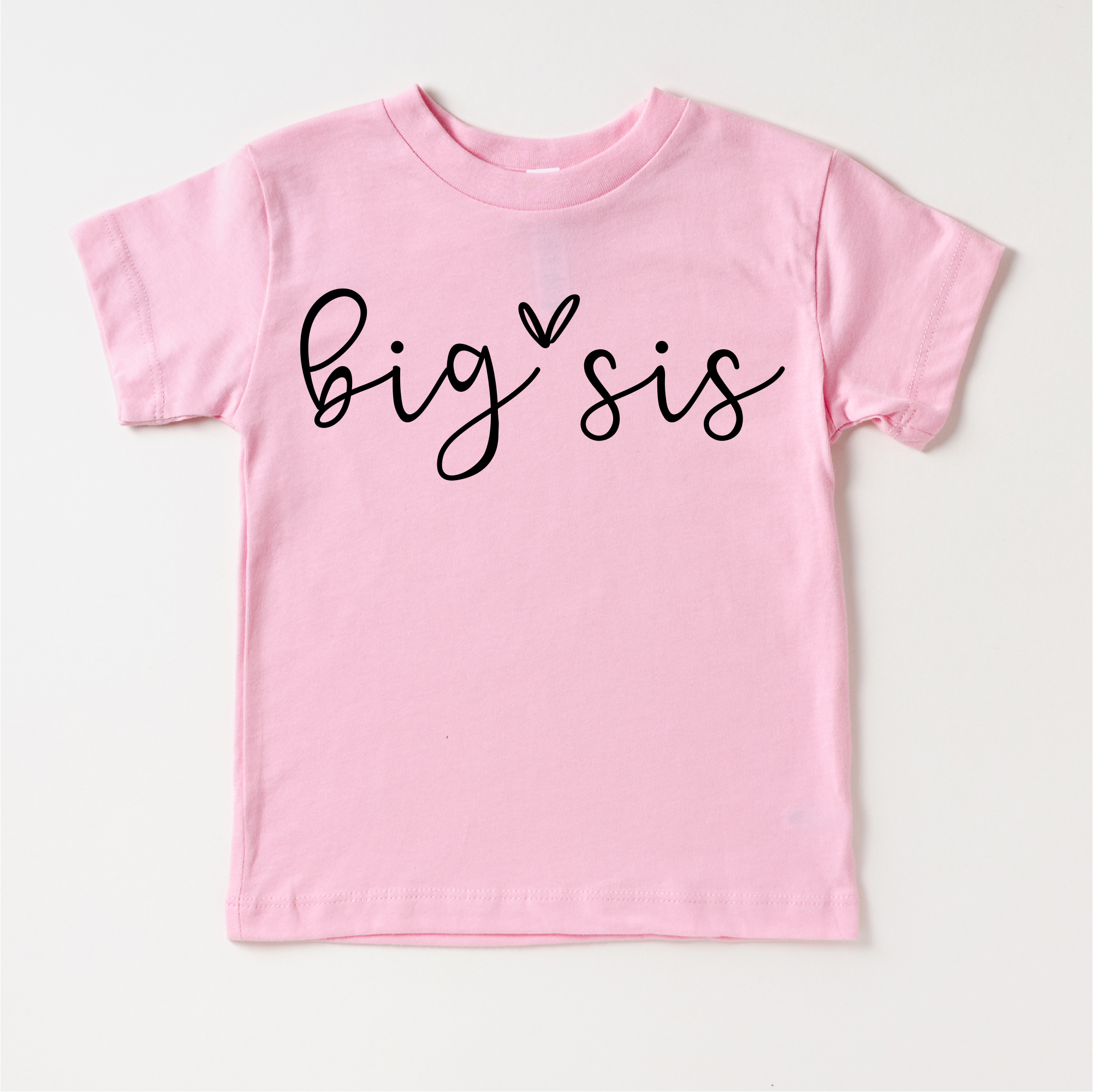 Pink t-shirt with 'big sis' text on a white background