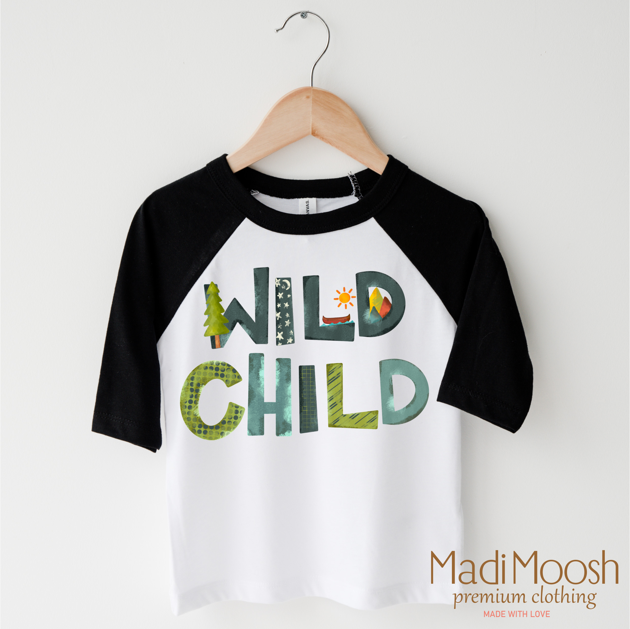 Children's 3/4 sleeve shirt with 'Wild Child' text on a hanger, featuring Madi Moosh branding.