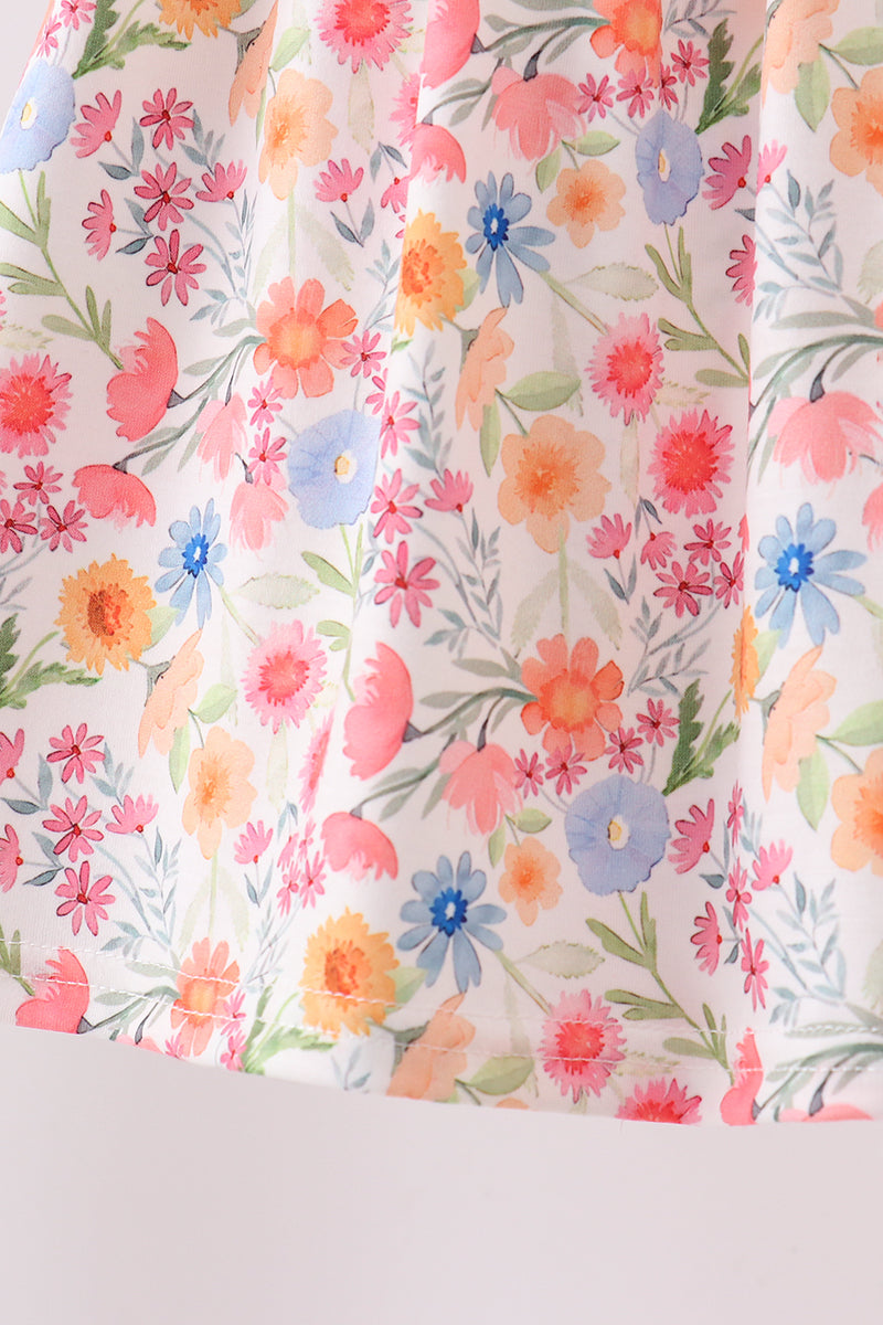 Floral patterned fabric with pink, orange, and blue flowers on a white background