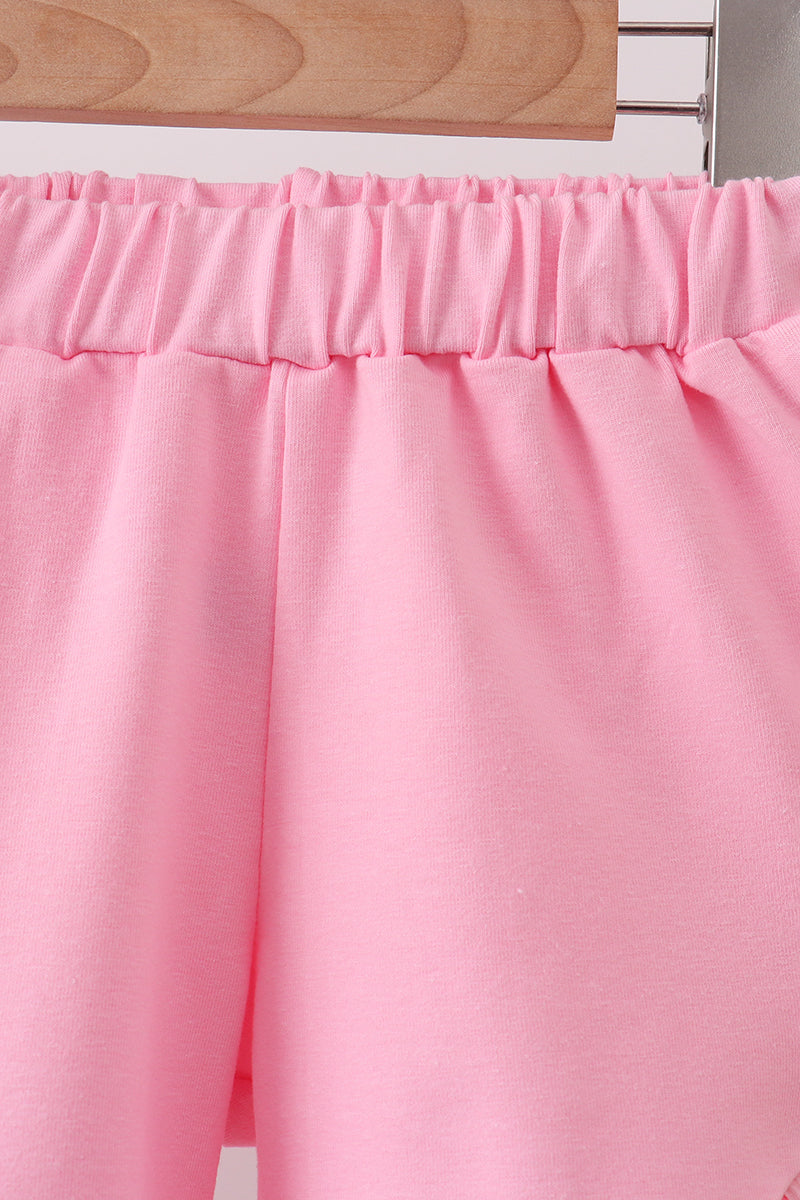 Close-up of pink fabric with a wooden surface in the background
