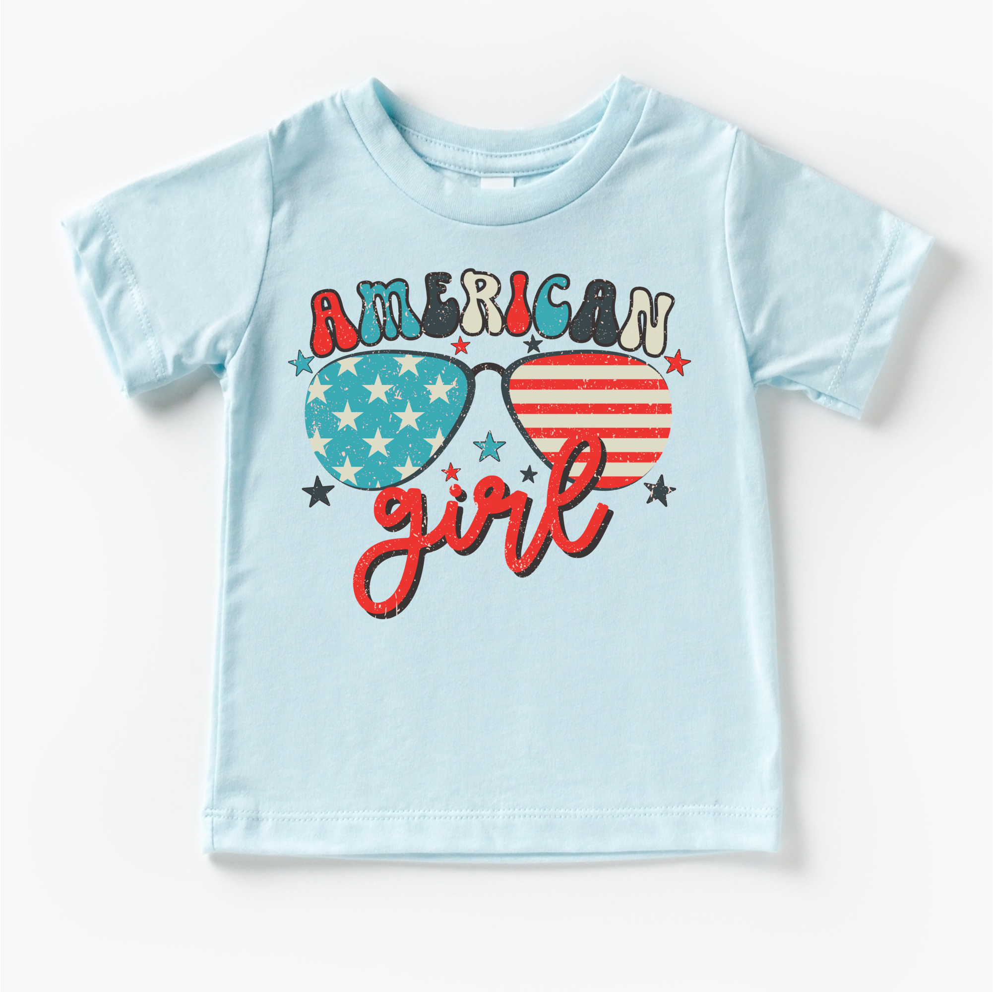 Light blue t-shirt with 'American Girl' design featuring sunglasses and hearts on a white background