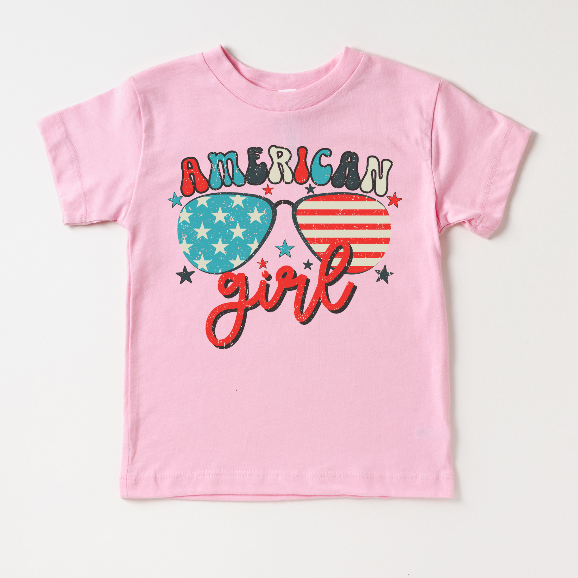 Pink t-shirt with 'American Girl' design on a white background