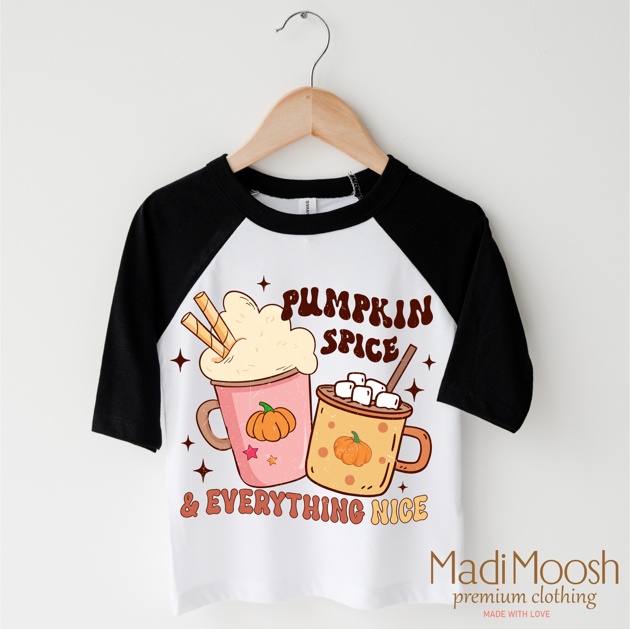 Children's 3/4 sleeve shirt with pumpkin spice design on a hanger