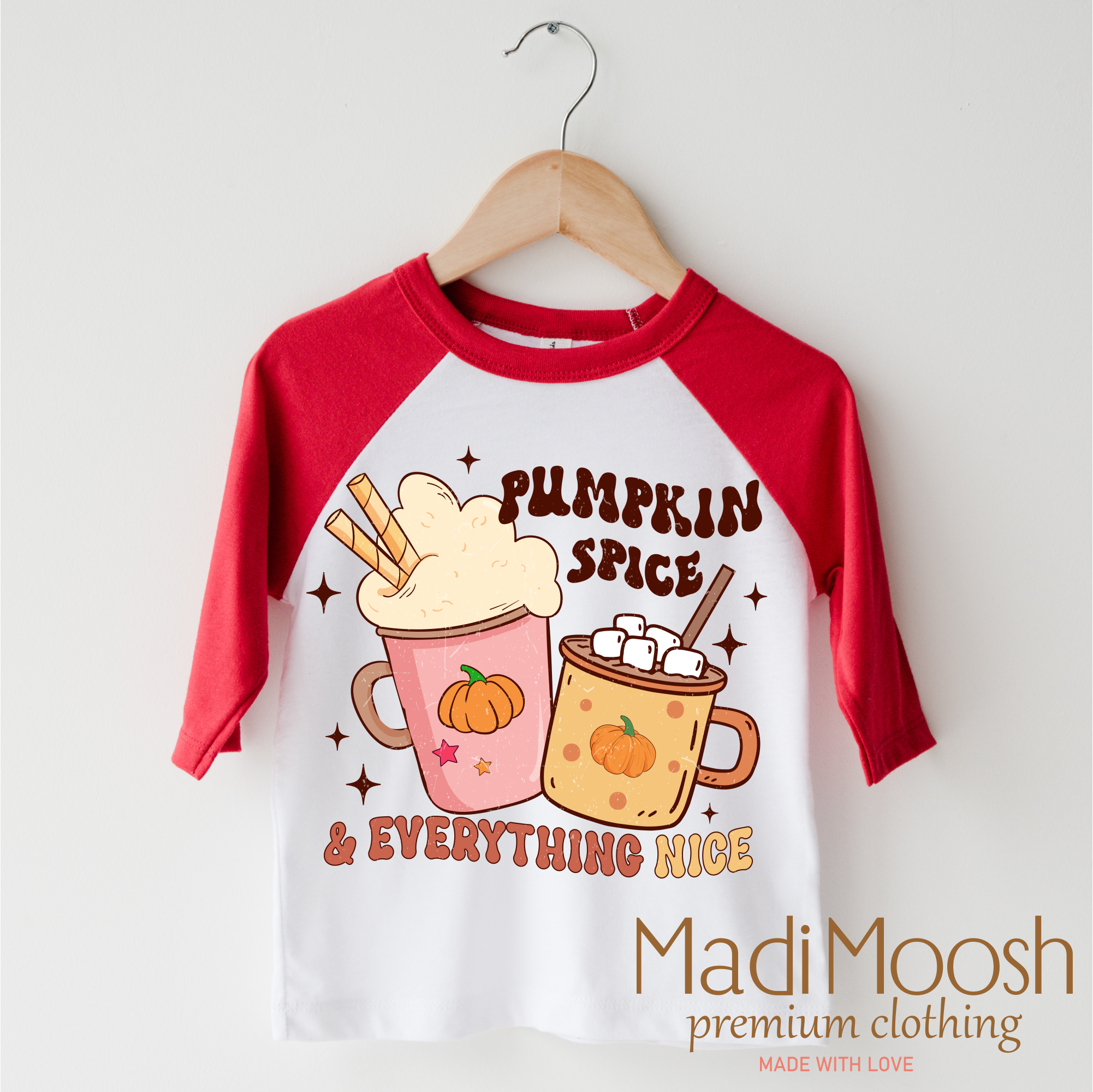 Children's 3/4 sleeve shirt with pumpkin spice design and 'Madi Moosh' branding on a hanger. 