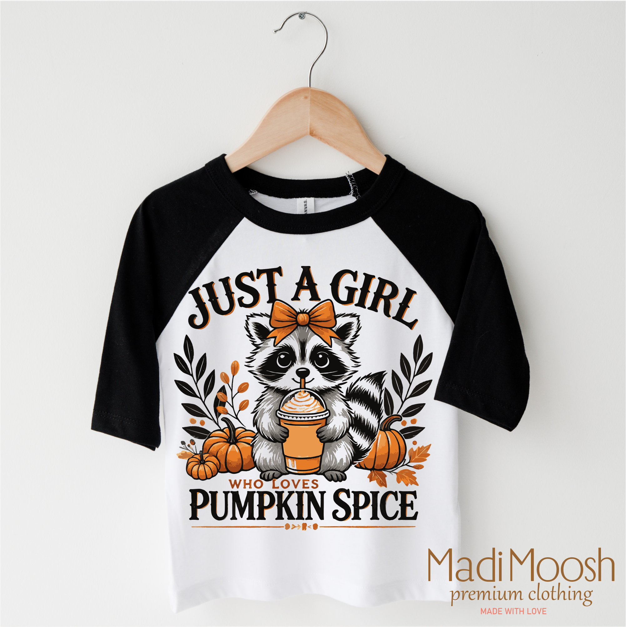 Children's 3/4 sleeve shirt with raccoon graphic and text on a hanger