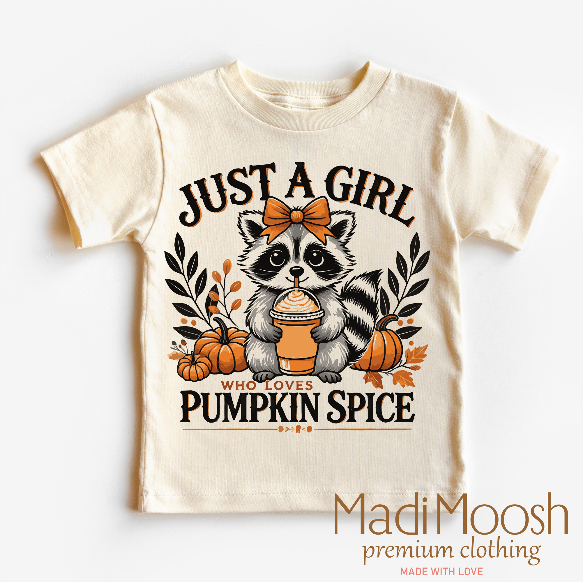 Children's t-shirt with raccoon graphic and text 'Just a girl who loves pumpkin spice' on a white background.