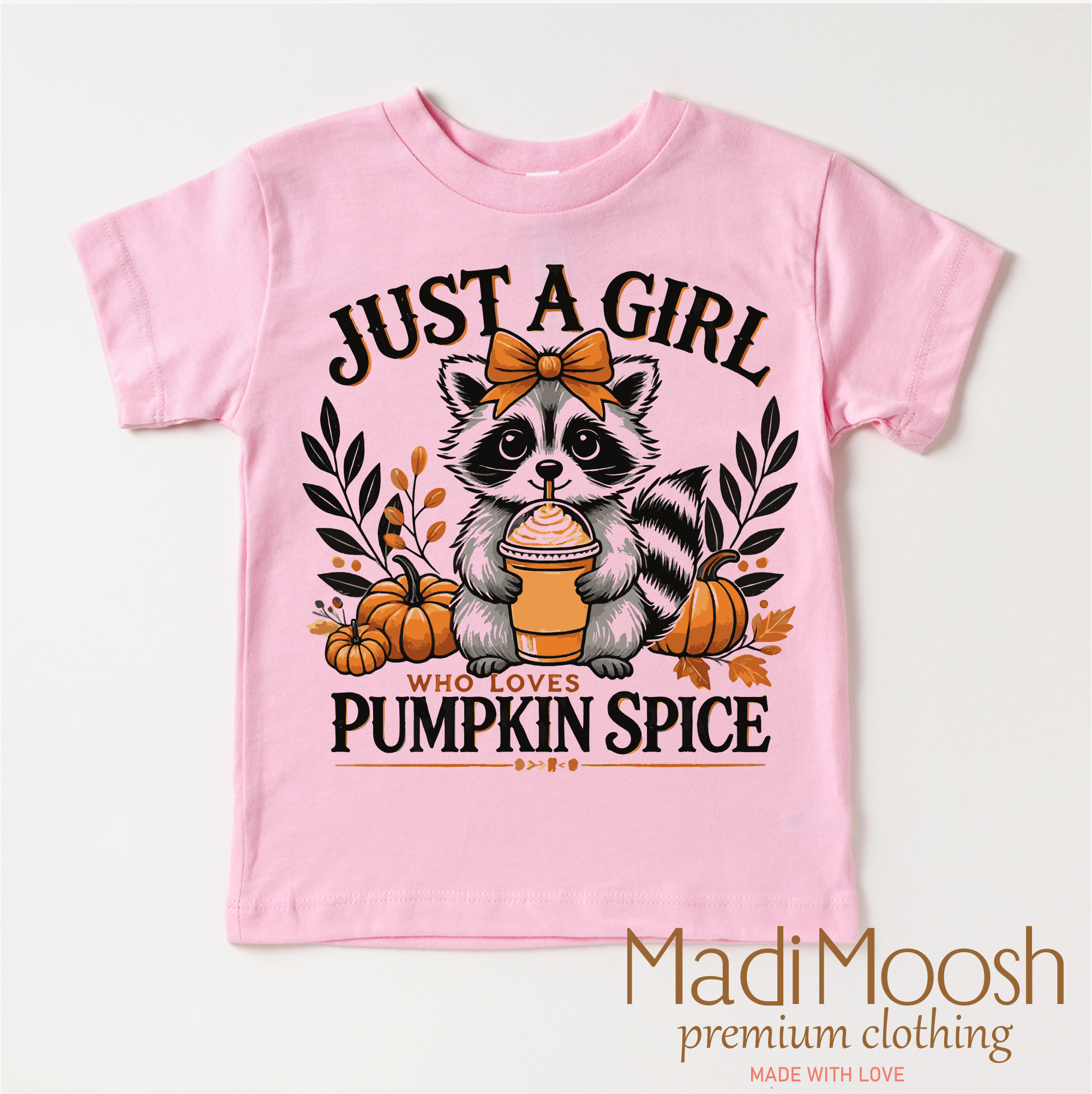 Pink t-shirt with raccoon graphic and 'Just a Girl Who Loves Pumpkin Spice' text on a white background.
