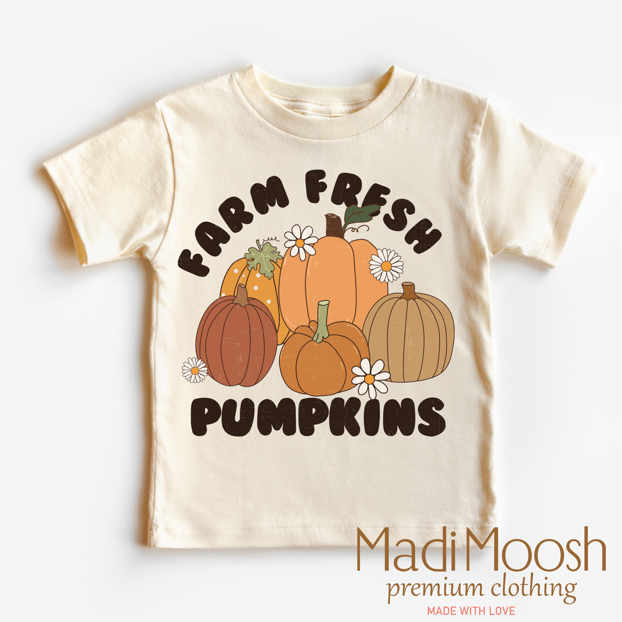Beige t-shirt with 'Farm Fresh Pumpkins' text and pumpkin graphics on a white background, featuring the brand 'Madi Moosh'.